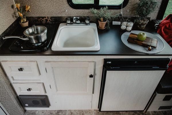 Kitchen with cooktop and fridge